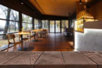 Empty wooden table in restaurant, space for design