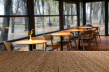 Empty wooden table in stylish cafe. Space for design