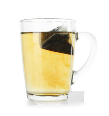 Tea bag in glass cup with hot drink isolated on white