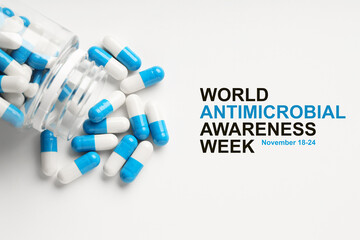 World antimicrobial awareness week. Bottle and scattered pills on white background, top view