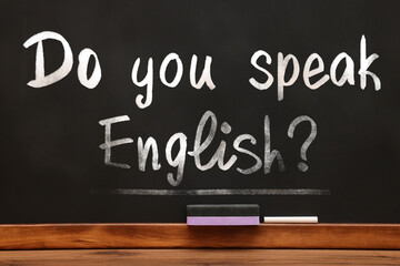 Do You Speak English? text on black chalkboard. Language course