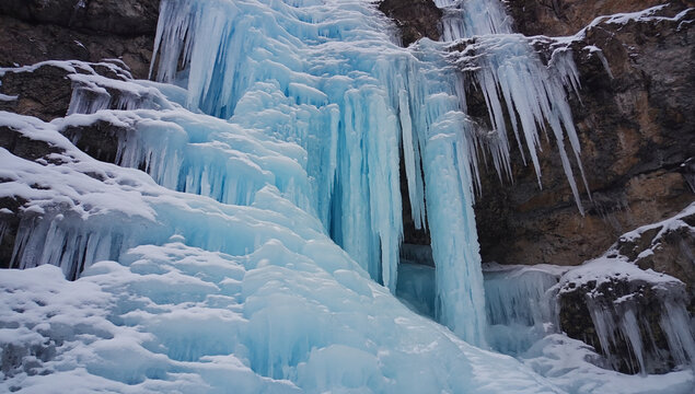 Frozen Waterfall: A breathtaking icy cascade, where crystal-clear icicles cling to the rocky cliffs, forming an enchanting winter wonderland. The serene beauty of frozen water.