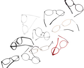 Different stylish glasses in air on white background. Fashionable accessory