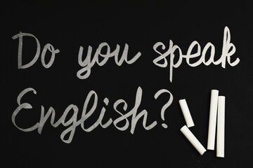 Do You Speak English? text on black chalkboard, top view. Language course