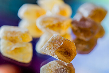 Detail brown sugar rock candy kandis on a neutral background