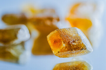 Detail brown sugar rock candy kandis on a neutral background