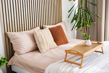Modern bedroom with stylish decor and a cozy breakfast tray at morning light
