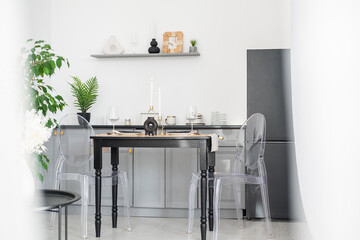 Modern dining room with minimalist decor and clear chairs