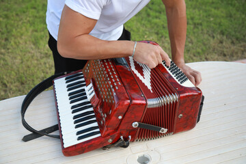 Man Using Tool To Fix And Tune Accordion 