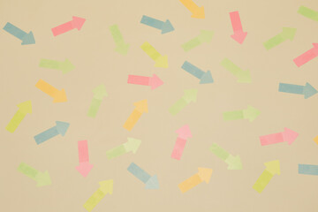 Pattern background texture with multitude of arrow stickers of different colors randomly pointing in different directions
