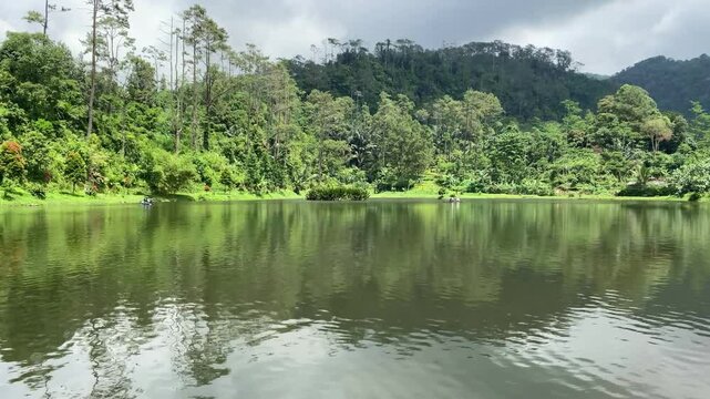 Hidden in the pine forests of Gununglurah, Telaga Kumpe is a serene mountain lake nestled on Mount Slamet's slopes. 
