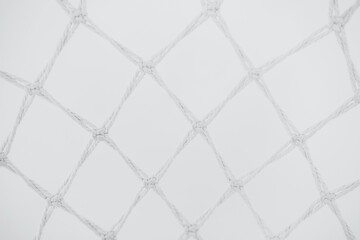 Fototapeta premium Detailed view of a sports net hanging in an indoor facility