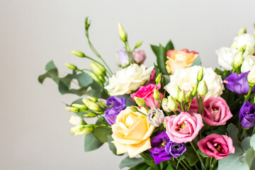 Celebrate special occasions with a colorful summer bouquet featuring fresh roses, eucalyptus, and eustoma blooms, creating an elegant and fragrant floral arrangement