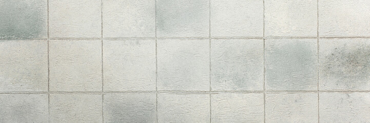 Fototapeta premium Gray tiles create a sleek and glossy background, adding depth and sophistication to any interior or design project, banner