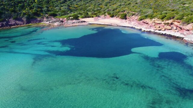 Aerial view of Porto Ferro shoreline on a sunny day. Sardinia, Italy