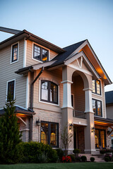 Obraz premium Luxury Home Exterior at Dusk: Modern Architectural Design, Landscaping, and Evening Lighting
