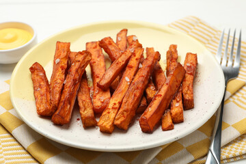 Delicious sweet potato fries and sauce on table, closeup