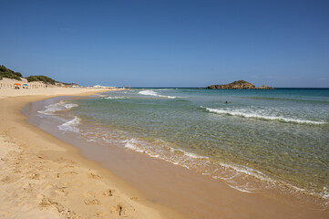 The beautiful beach of Su Giudeu in the south of Sardinia with transparent and turquoise water and a small island in front of the bay