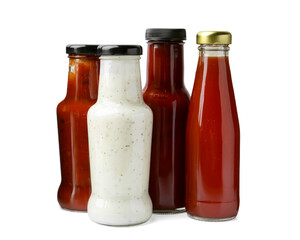 Different delicious sauces in glass bottles isolated on white