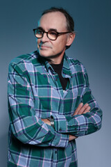 Handsome middle aged man wearing glasses & blue checked shirt, head & shoulders