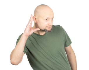 Curious man listening attentively with hand to ear