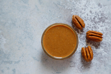 Homemade nuts butter in a glass jars with various nuts.