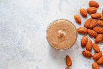 Homemade nuts butter in a glass jars with various nuts.