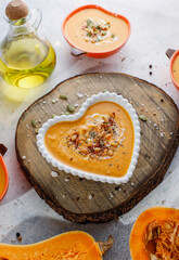 Traditional autumn butternut squash soup with seeds.
