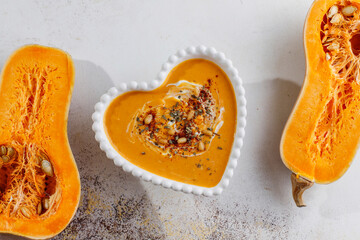 Traditional autumn butternut squash soup with seeds.