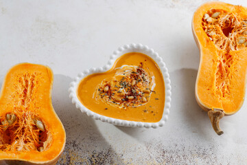 Traditional autumn butternut squash soup with seeds.