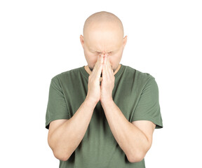 Worried bald man in green t-shirt pressing hands together