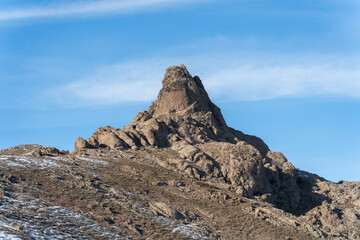 Natural rock formation in the Chatkal Range, Tian Shan Mountains in Uzbekistan in sunny winter weather.