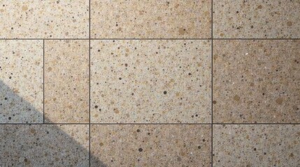 Naklejka premium Speckled Terrazzo Tile Surface with Shadowed Section Displaying Textured Pattern