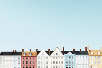Fototapeta premium Colorful row of buildings against clear blue sky, showcasing architectural diversity and charm