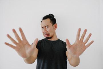 Man in black t-shirt do deny pose isolated on white.