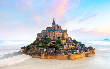 Mont Saint-Michel island with abbey and small town in the sunset light. Normandy, northern France