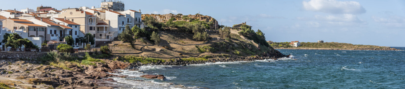 Coastline of Sant'Antioco Island with high red cliffs and rough sea
