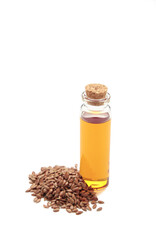 Flaxseeds with flaxseed glass bottle oil isolated on white background.