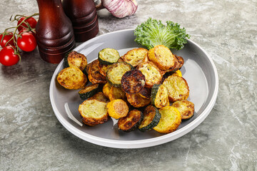 Roasted young zucchini in the plate