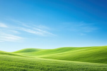 Fototapeta premium Majestic Green Rolling Hills Under Clear Blue Sky