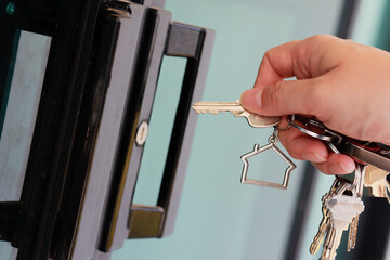 Locking or unlocking a key to enter or exit a residence.