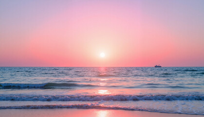 Obraz premium Tranquil ocean waves under a pink sunset sky, celebrating World Water Day