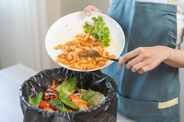 Compost from leftover food asian young housekeeper woman, girl hand holding macaroni plate use fork...