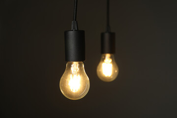 Light bulbs against grey background, selective focus. Space for text