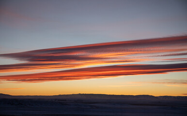 Beautiful red orange sunset in Wyoming long clouds