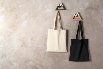 Eco bags hanging on grey wall,. Mockup for design