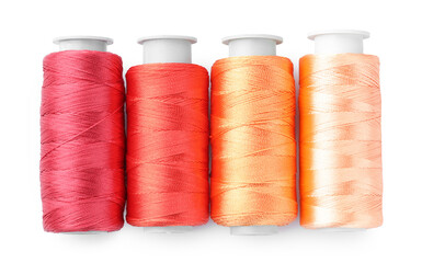 Spools of colorful sewing threads isolated on white, top view