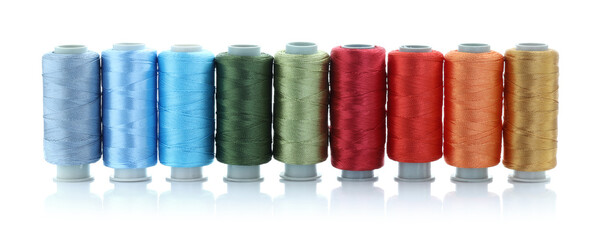 Spools of bright sewing threads isolated on white
