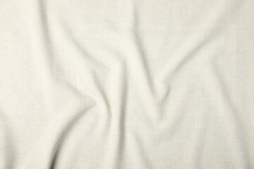 Texture of beige crumpled tablecloth as background, top view