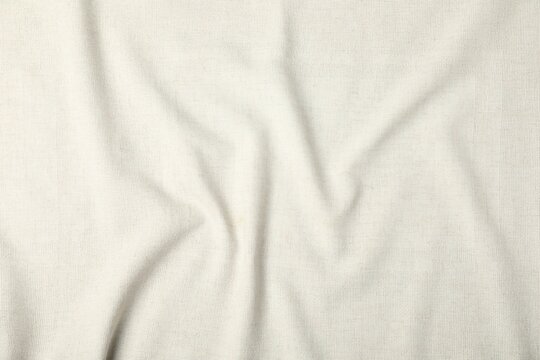 Fototapeta Texture of beige crumpled tablecloth as background, top view